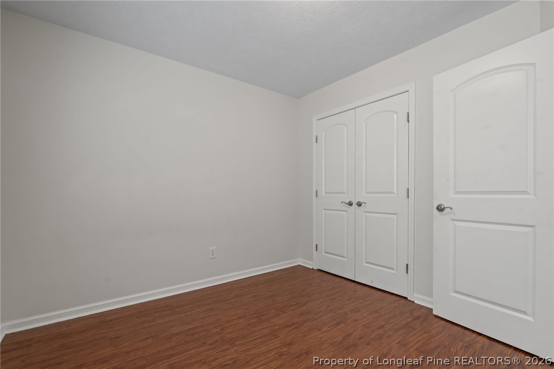 115 Shelby Street Spring Lake, NC 28390 - Photo 30 of 40 a view of an empty room with wooden floor