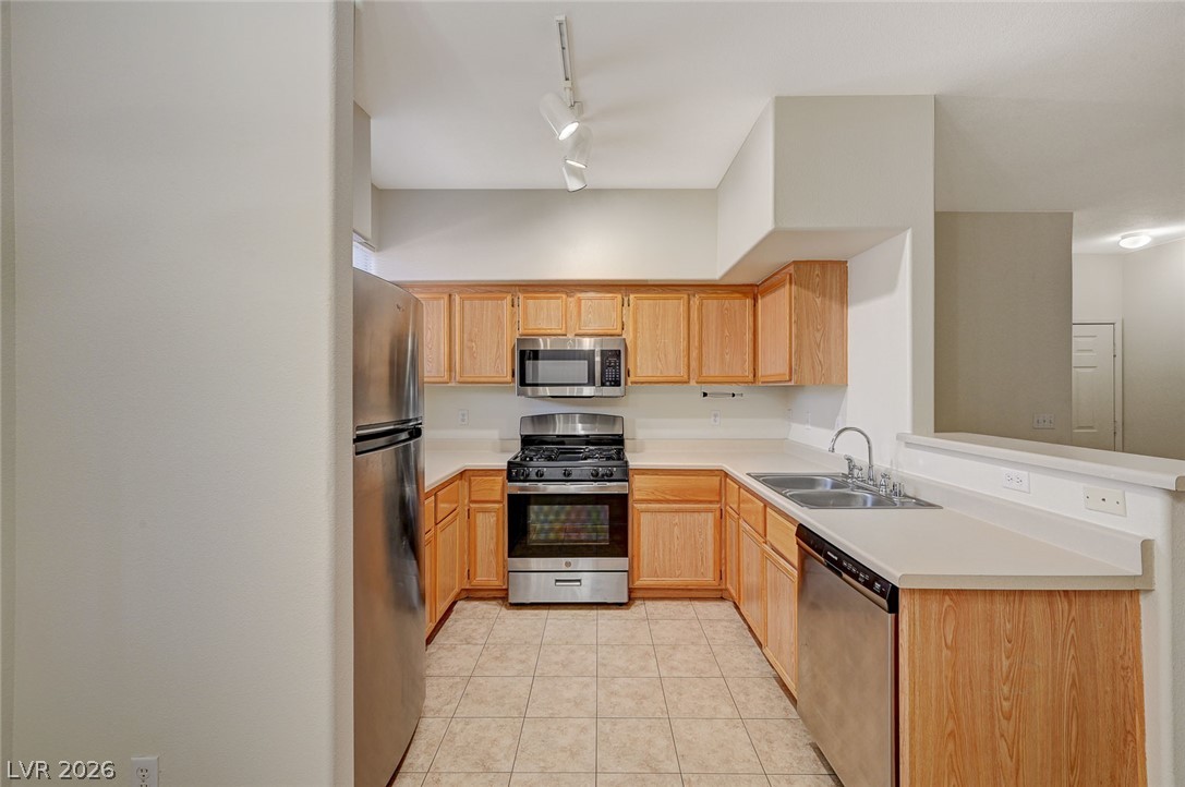 9050 West Warm Springs Road, Unit 1147 Las Vegas, NV 89148 - Photo 13 of 36 A well-appointed kitchen features stainless steel appliances and light wood cabinetry.