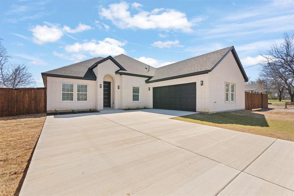 a view of a house with a backyard and a garage