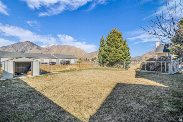 1836 West 800 North Mapleton, UT 84663 - Photo 29 of 38 Fenced backyard featuring a storage unit and a mountain view