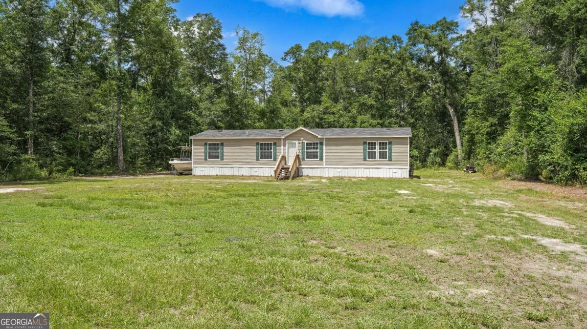 64 Sierra Road Jesup, GA 31545 - Photo 2 of 22 a view of house with outdoor space and garden