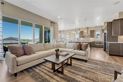 a living room with furniture kitchen view and a table