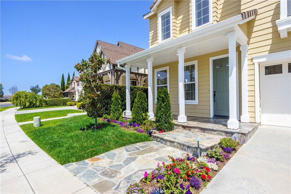 15 Plum Street Ladera Ranch, CA 92694 - Photo 5 of 113 a front view of a house with a garden