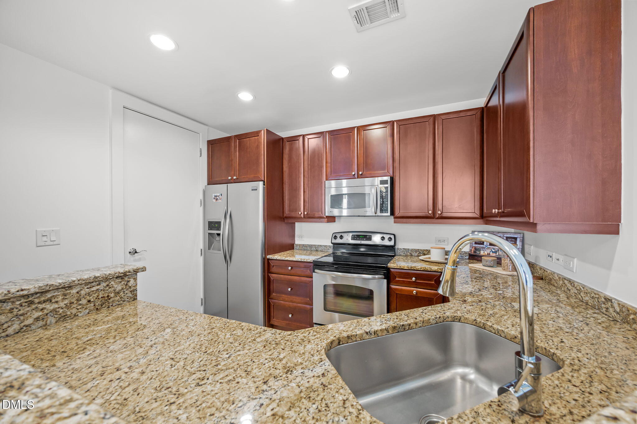 618 North Boylan Avenue, Unit 702 Raleigh, NC 27603 - Photo 12 of 42 a kitchen with stainless steel appliances granite countertop a sink stove and refrigerator