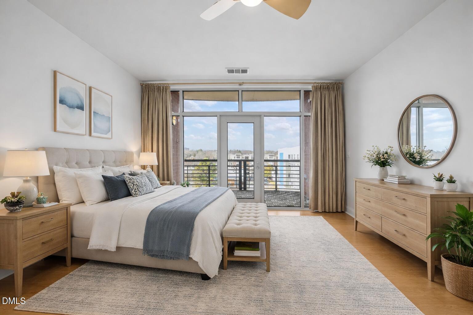 618 North Boylan Avenue, Unit 702 Raleigh, NC 27603 - Photo 14 of 42 a bedroom with a bed a mirror and a window