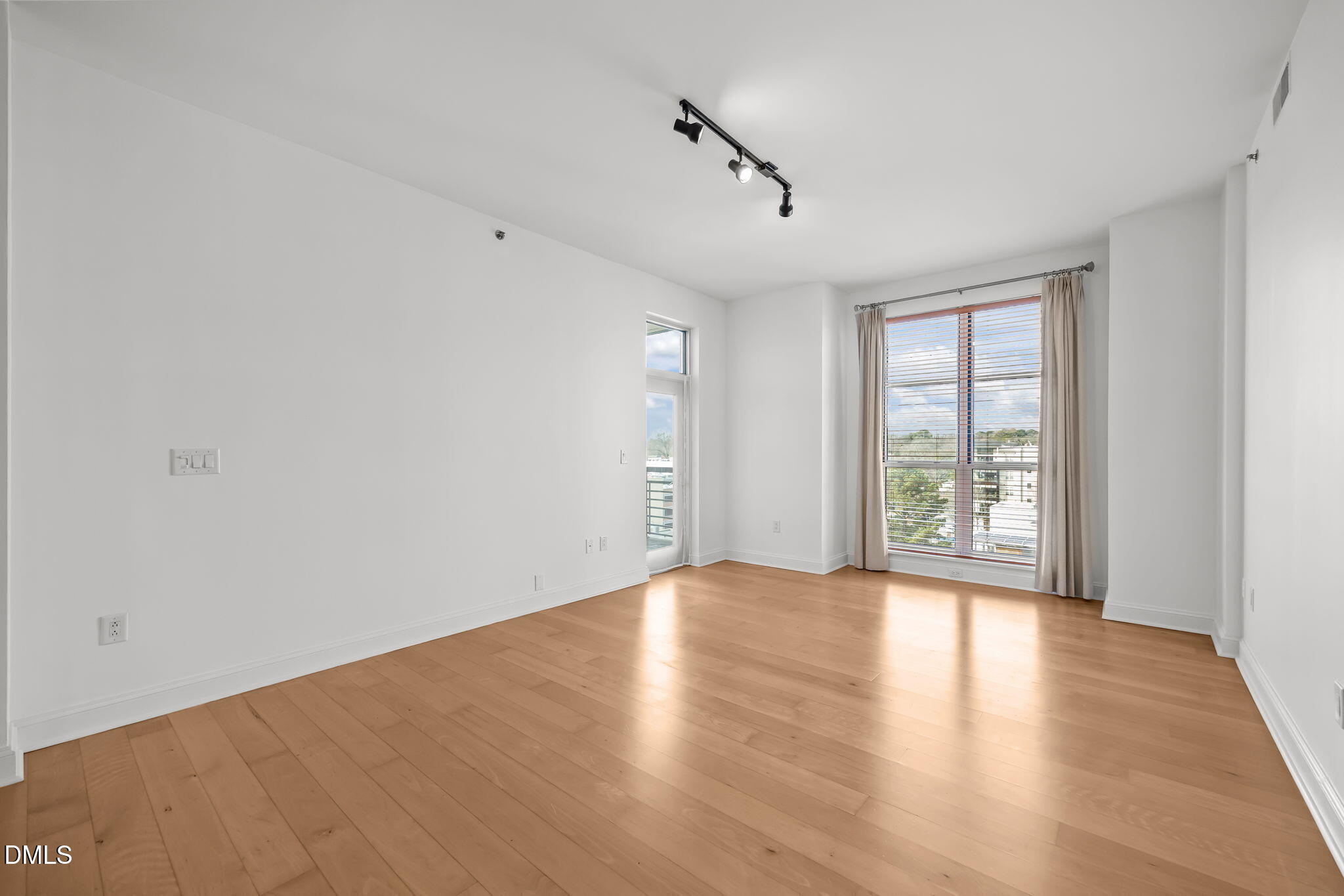 618 North Boylan Avenue, Unit 702 Raleigh, NC 27603 - Photo 2 of 42 a view of an empty room with wooden floor and a window