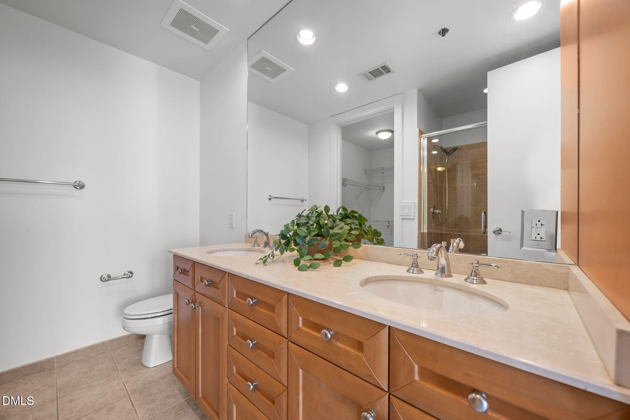 618 North Boylan Avenue, Unit 702 Raleigh, NC 27603 - Photo 25 of 42 a bathroom with a granite countertop sink a toilet and a mirror