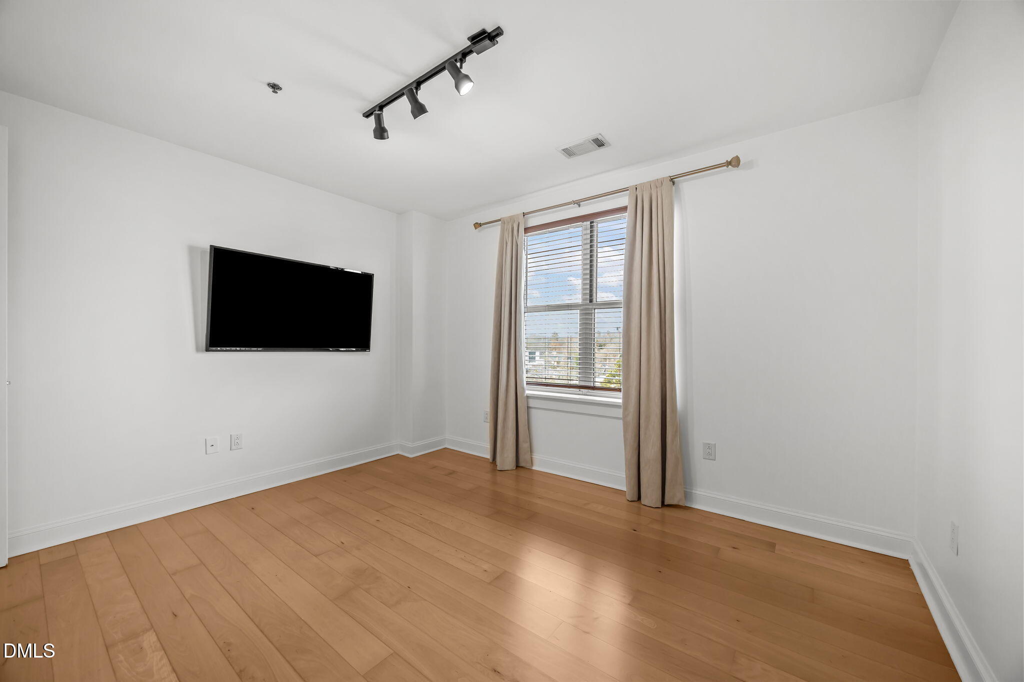 618 North Boylan Avenue, Unit 702 Raleigh, NC 27603 - Photo 28 of 42 a view of empty room with wooden floor and fan