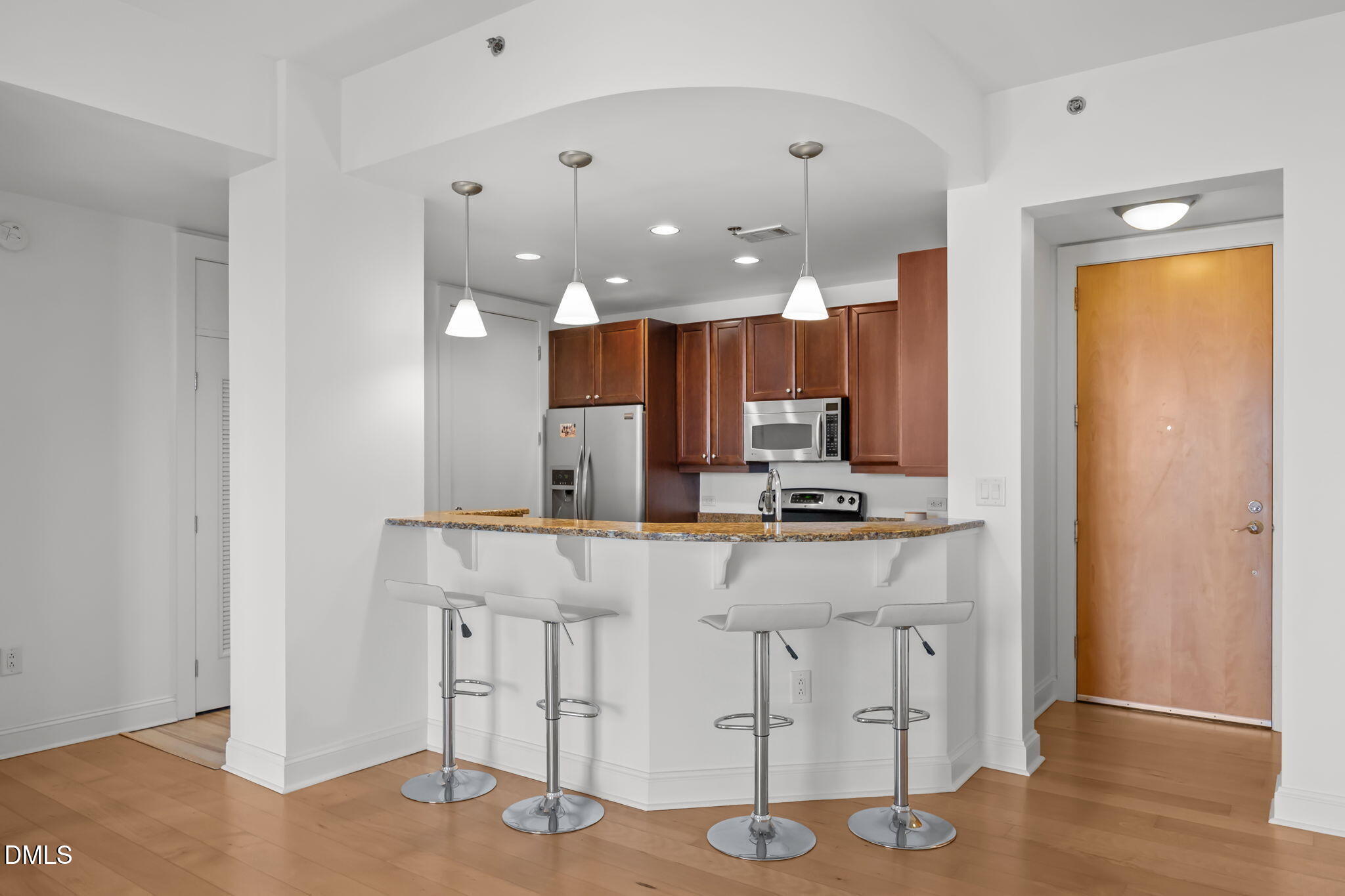 618 North Boylan Avenue, Unit 702 Raleigh, NC 27603 - Photo 5 of 42 a kitchen with kitchen island granite countertop a stove and a refrigerator