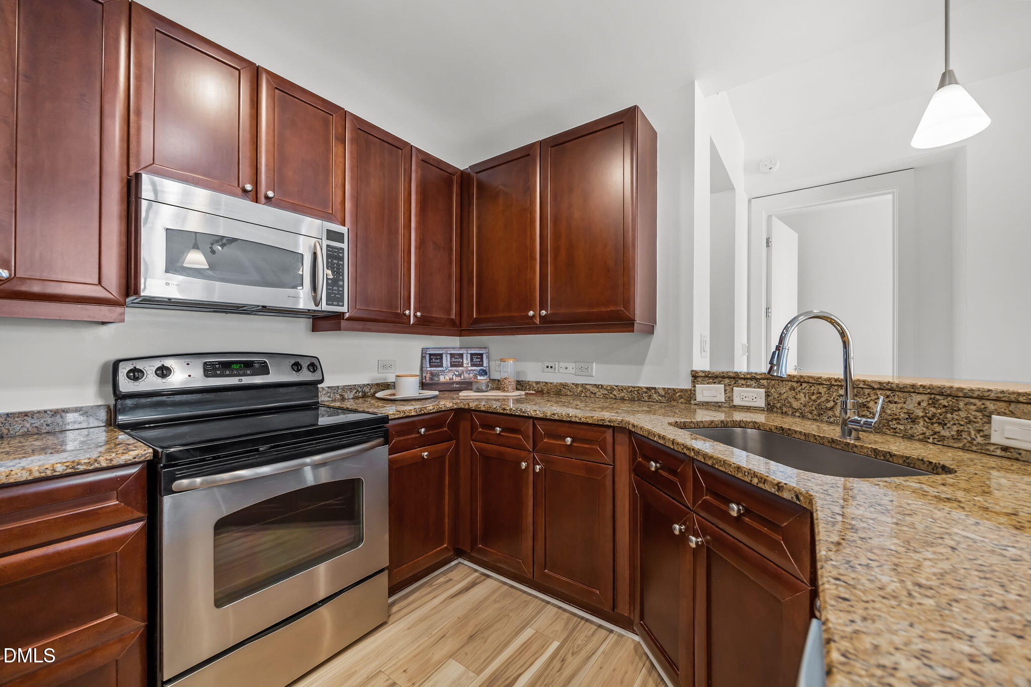 618 North Boylan Avenue, Unit 702 Raleigh, NC 27603 - Photo 6 of 42 a kitchen with a sink stove and microwave