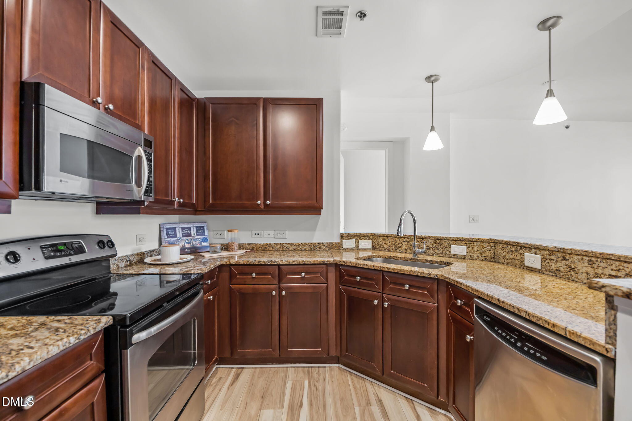 618 North Boylan Avenue, Unit 702 Raleigh, NC 27603 - Photo 7 of 42 a kitchen with a sink stove and microwave