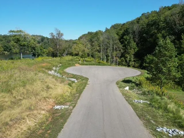 a aerial view of a residential houses with yard