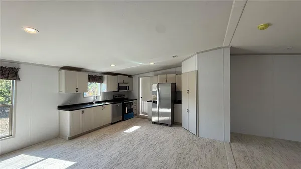 a kitchen with stainless steel appliances granite countertop a refrigerator and a sink
