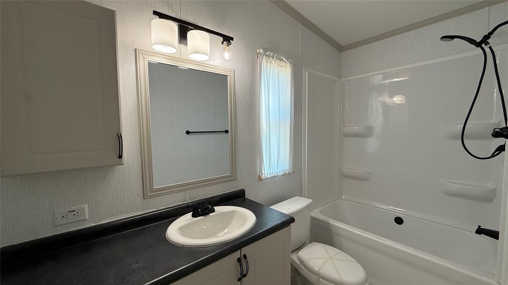 244 Overland Trail Runaway Bay, TX 76426 - Photo 14 of 15 a bathroom with a sink toilet and shower