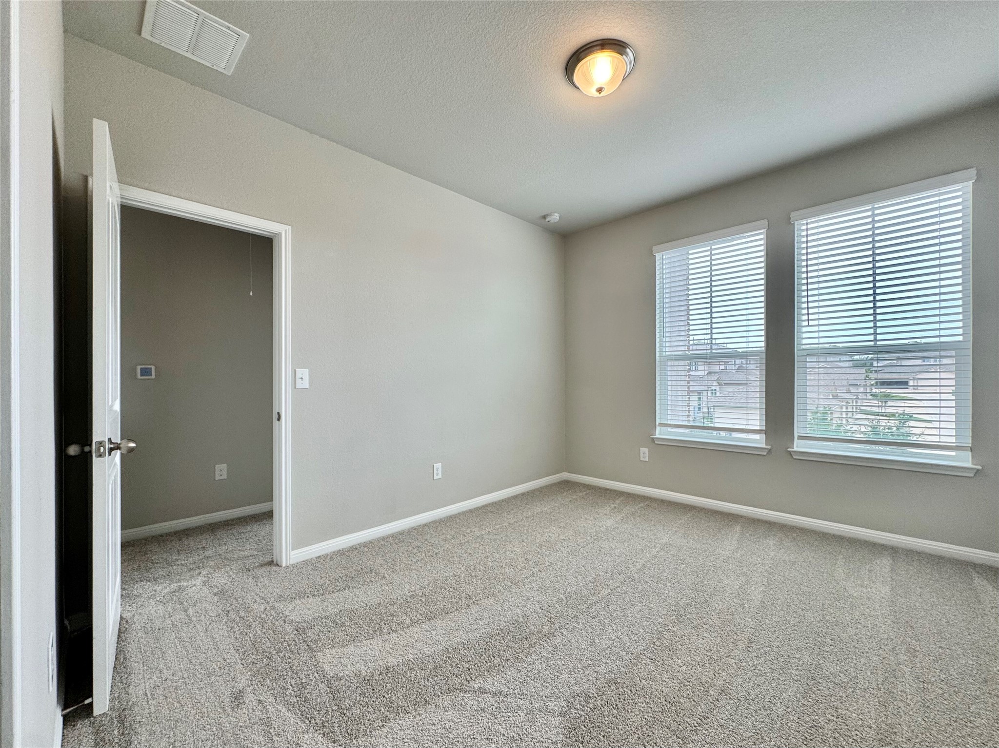 407 Rhetoric Way Pflugerville, TX 78660 - Photo 19 of 38 an empty room with windows and closet