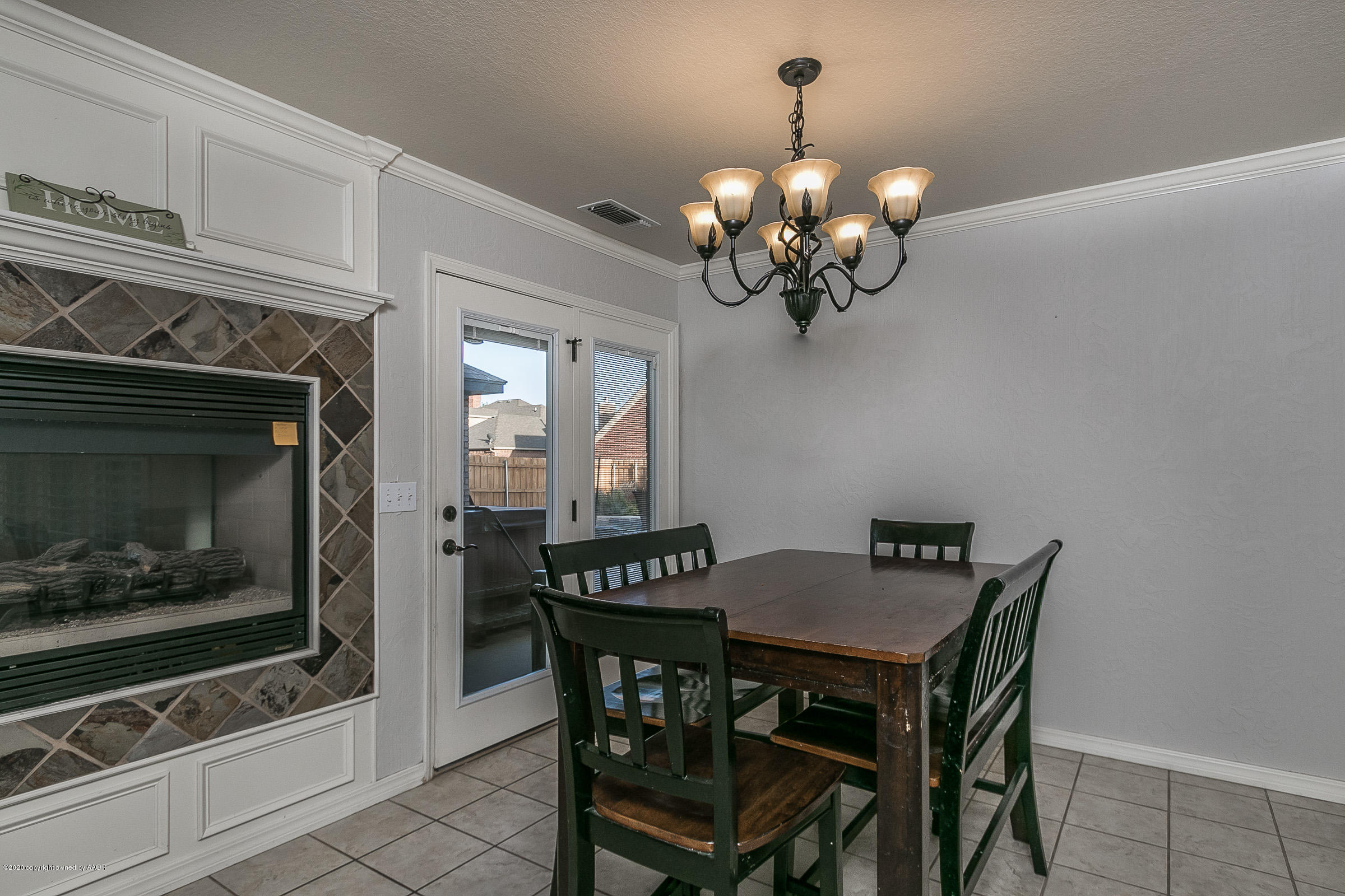 7411 Countryside Drive Amarillo, TX 79119 - Photo 14 of 39 a dining room with furniture a chandelier and window
