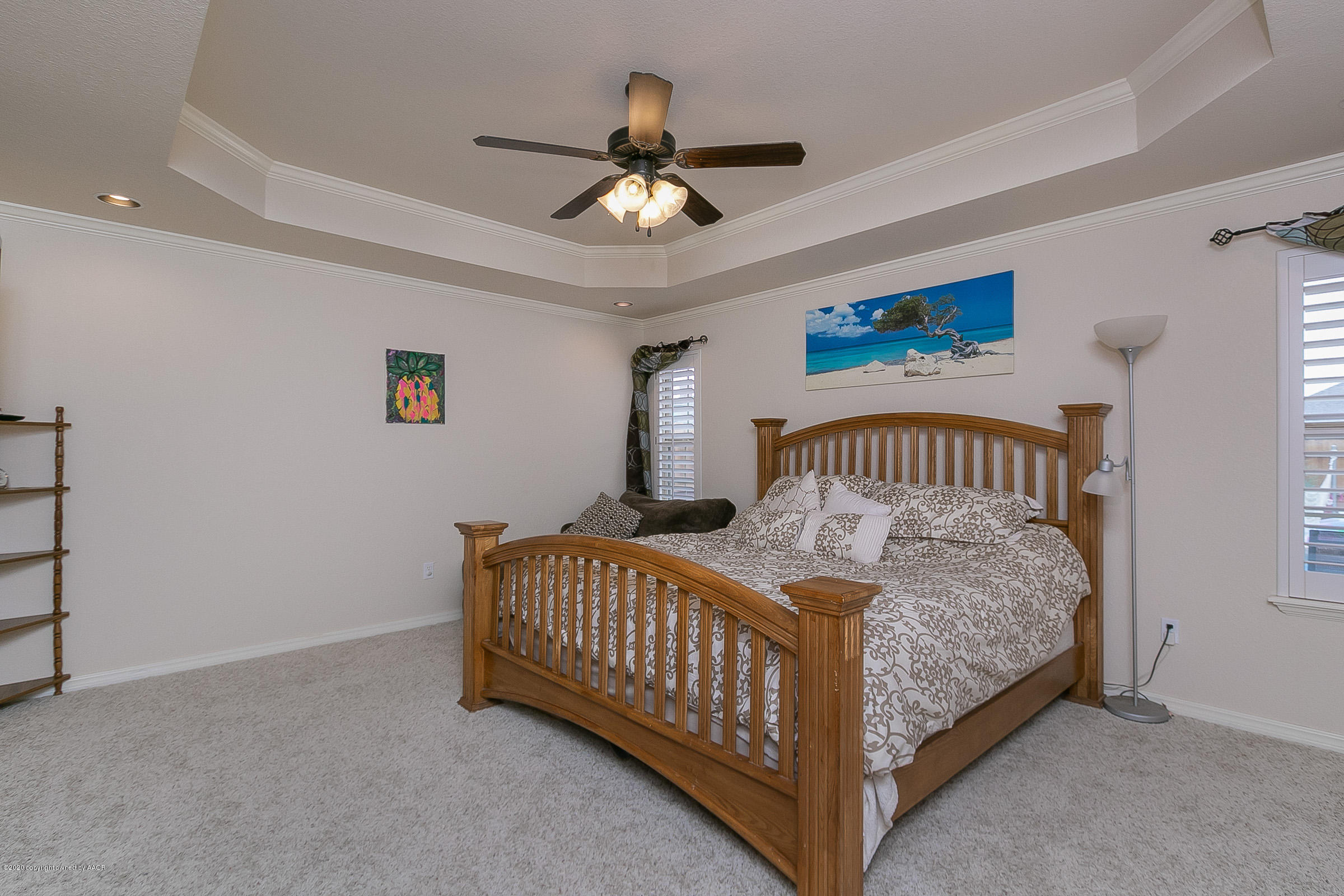 7411 Countryside Drive Amarillo, TX 79119 - Photo 16 of 39 a bedroom with a bed and a chandelier