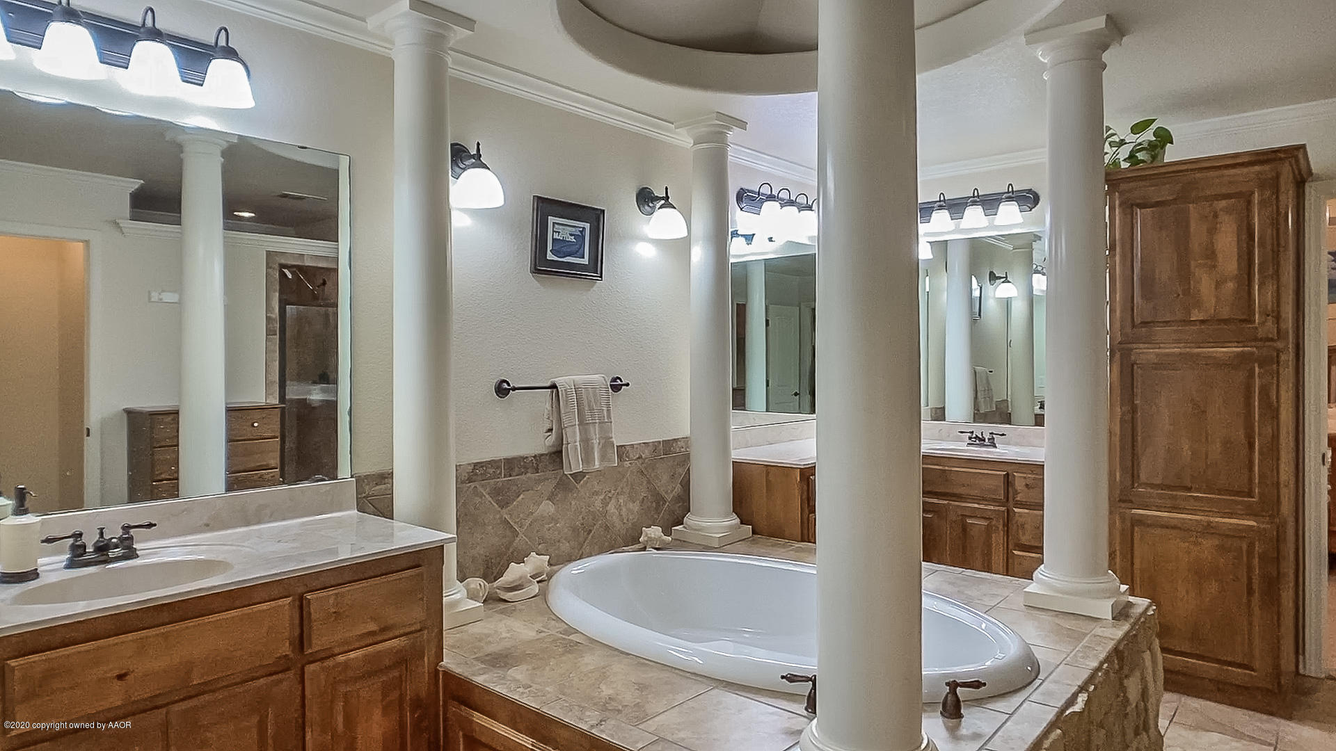 7411 Countryside Drive Amarillo, TX 79119 - Photo 17 of 39 a bathroom with a granite countertop tub sink and mirror