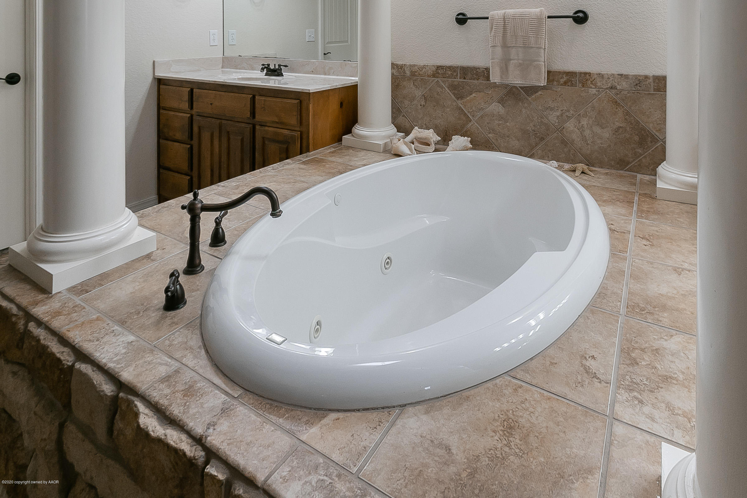7411 Countryside Drive Amarillo, TX 79119 - Photo 19 of 39 a bathroom with a granite countertop sink and a mirror