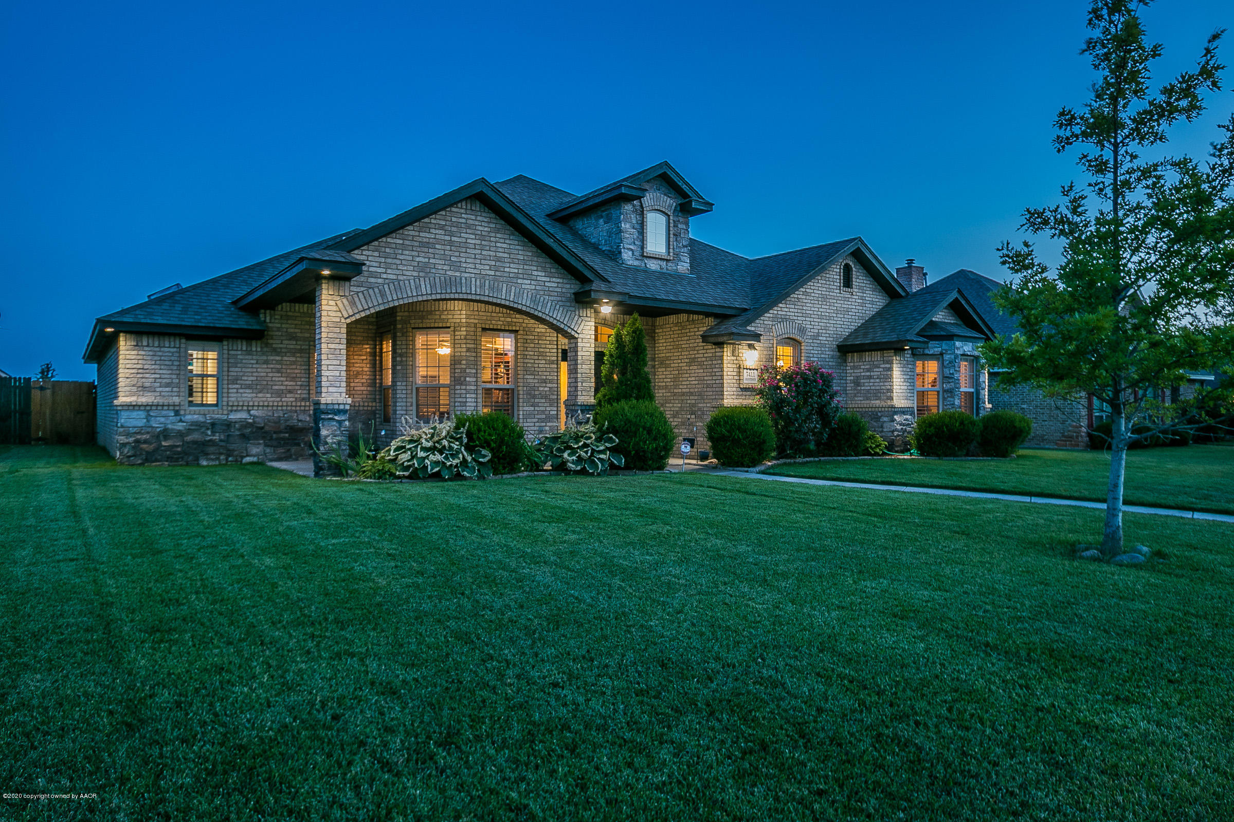 7411 Countryside Drive Amarillo, TX 79119 - Photo 2 of 39 a front view of a house with a garden