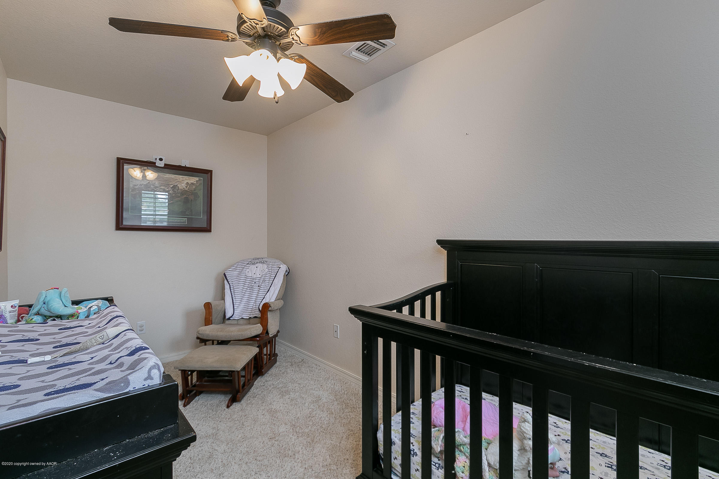 7411 Countryside Drive Amarillo, TX 79119 - Photo 25 of 39 a bedroom with furniture and a ceiling fan