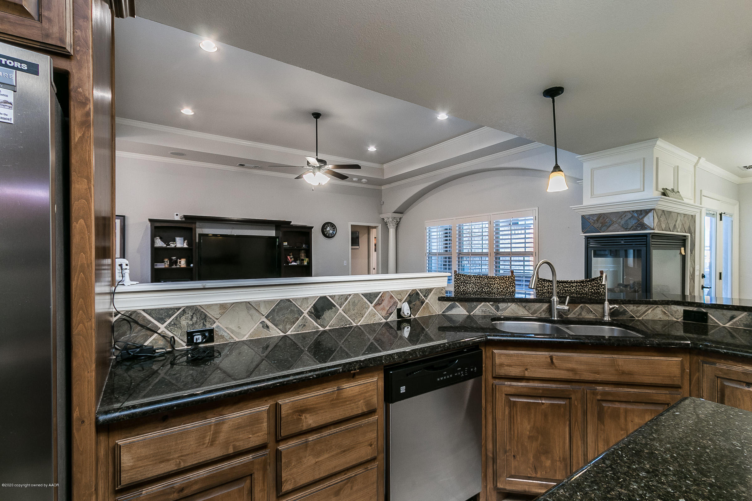 7411 Countryside Drive Amarillo, TX 79119 - Photo 34 of 39 a kitchen with stainless steel appliances granite countertop a sink and a stove top oven
