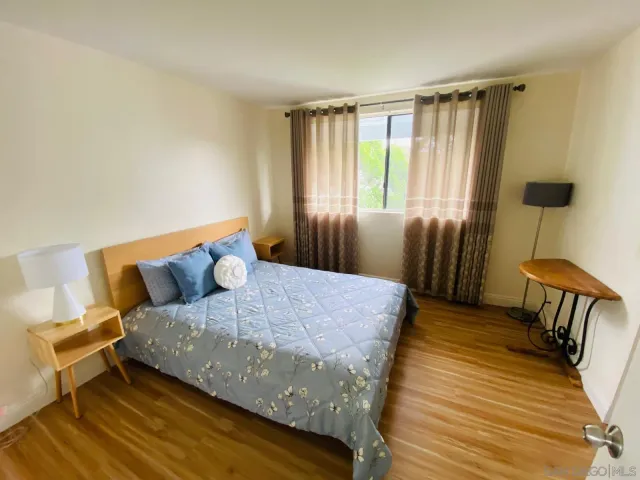 a bedroom with a bed and a mirror