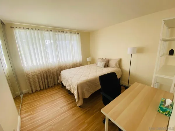 a bedroom with a bed and a mirror