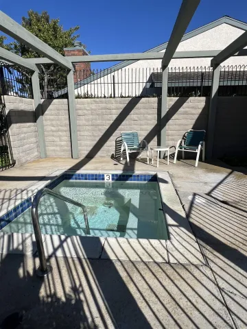 a yard with lots of trees and wooden fence