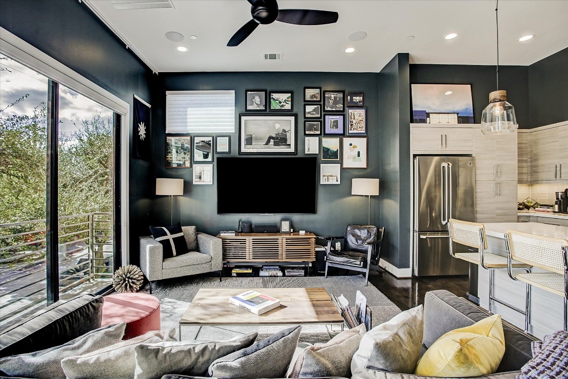 1004 California Street, Unit 101 Houston, TX 77006 - Photo 12 of 27 a living room with furniture and a flat screen tv