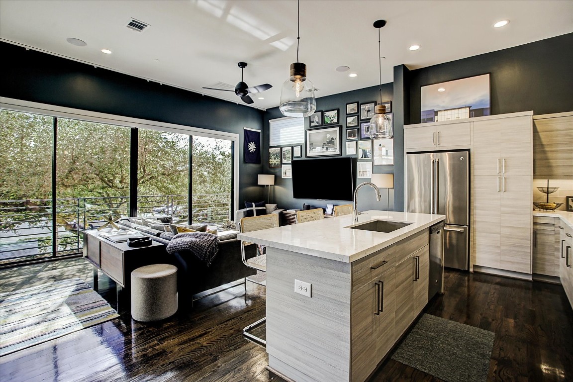 1004 California Street, Unit 101 Houston, TX 77006 - Photo 13 of 27 a kitchen that has a sink a stove and a refrigerator