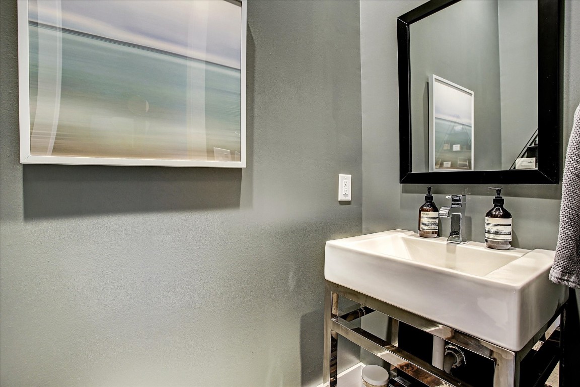 1004 California Street, Unit 101 Houston, TX 77006 - Photo 17 of 27 a bathroom with a sink a mirror and a vanity