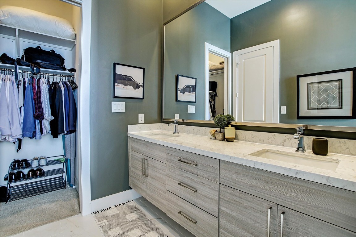 1004 California Street, Unit 101 Houston, TX 77006 - Photo 22 of 27 a bathroom with a double vanity sink and a mirror