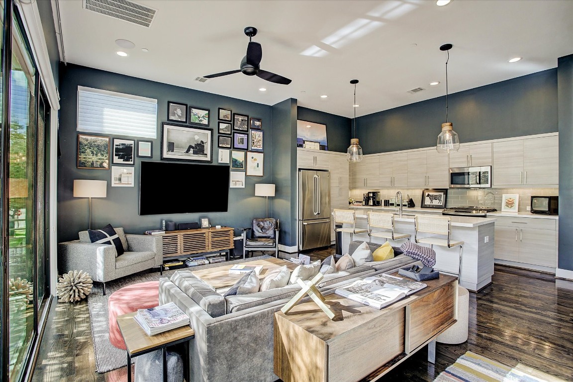 1004 California Street, Unit 101 Houston, TX 77006 - Photo 7 of 27 a living room with stainless steel appliances furniture and a flat screen tv
