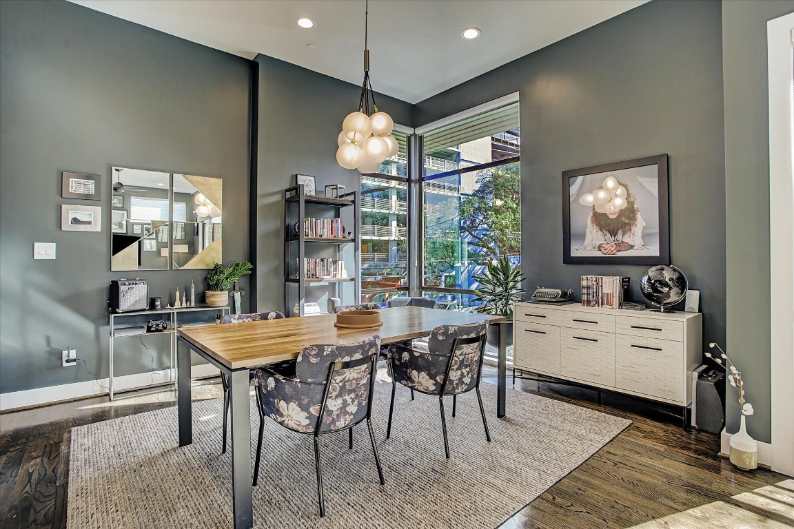1004 California Street, Unit 101 Houston, TX 77006 - Photo 9 of 27 a room with stainless steel appliances kitchen island granite countertop furniture and a chandelier
