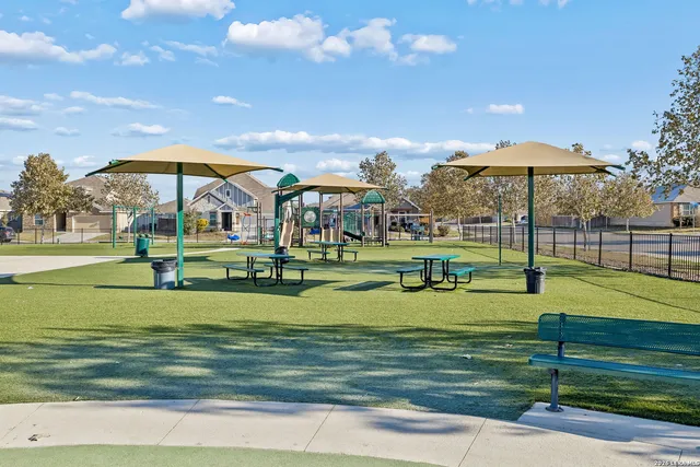 a view of a park with swings and slides