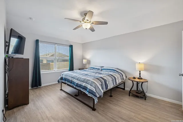 a bedroom with a bed and wooden floor