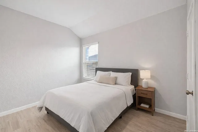 a bedroom with a bed and a night stand