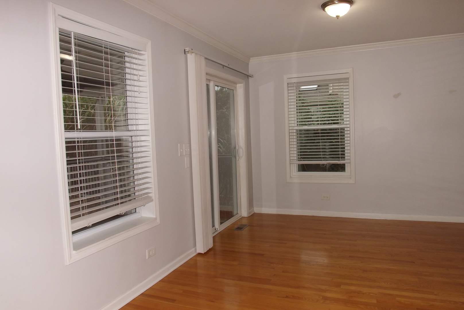 433 Prairie Valley Street Elburn, IL 60119 - Photo 11 of 21 a view of an empty room with wooden floor and a window