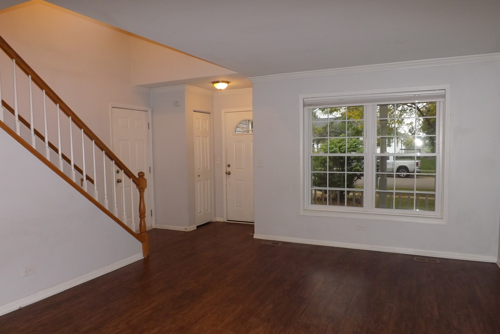 433 Prairie Valley Street Elburn, IL 60119 - Photo 5 of 21 a view of an empty room with wooden floor and a window