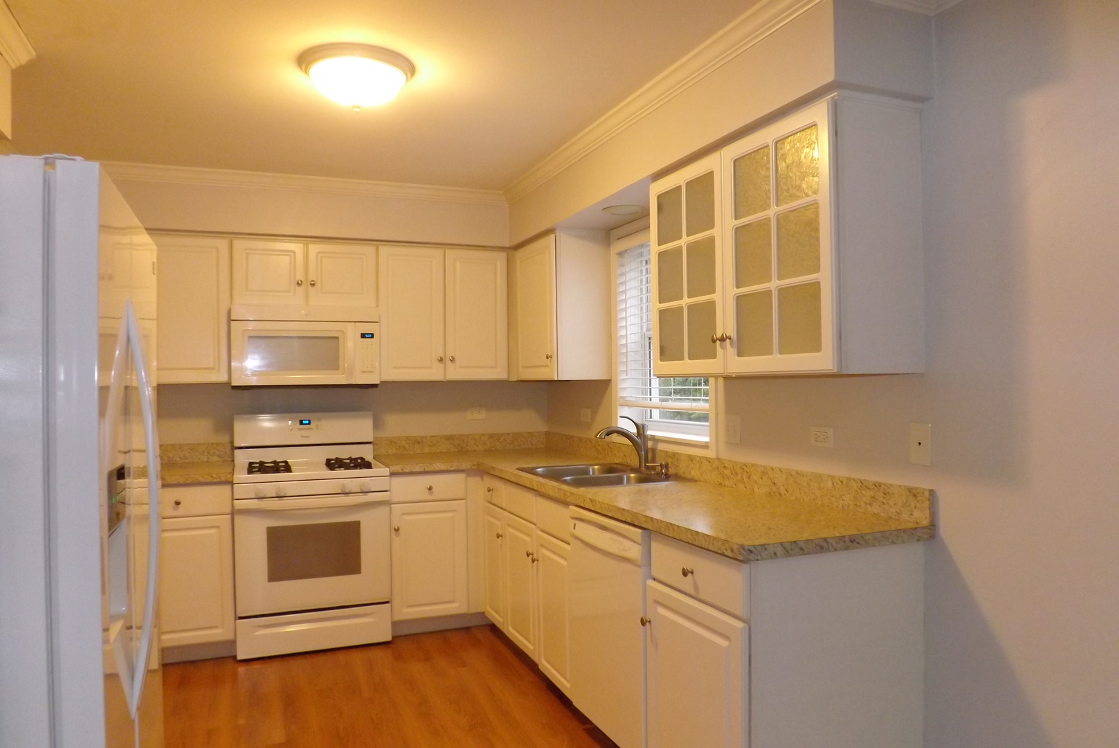 433 Prairie Valley Street Elburn, IL 60119 - Photo 9 of 21 a kitchen with a sink stove and cabinets