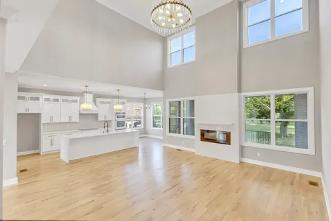 a spacious bedroom with a bed couch and a large window