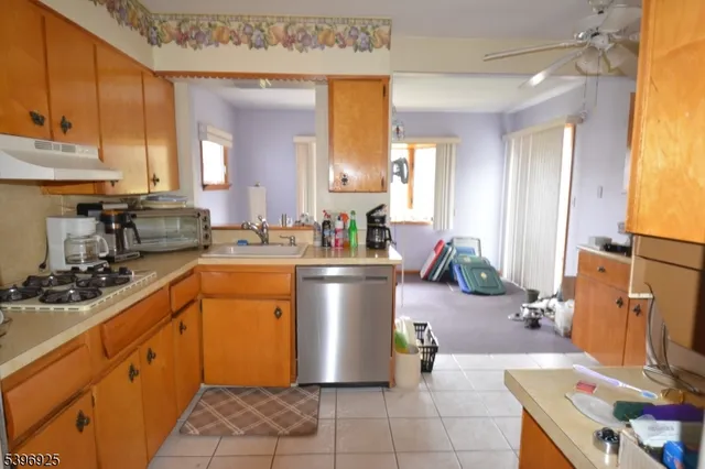 a kitchen with a sink stove and cabinets