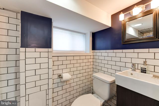 a bathroom with a sink toilet and mirror