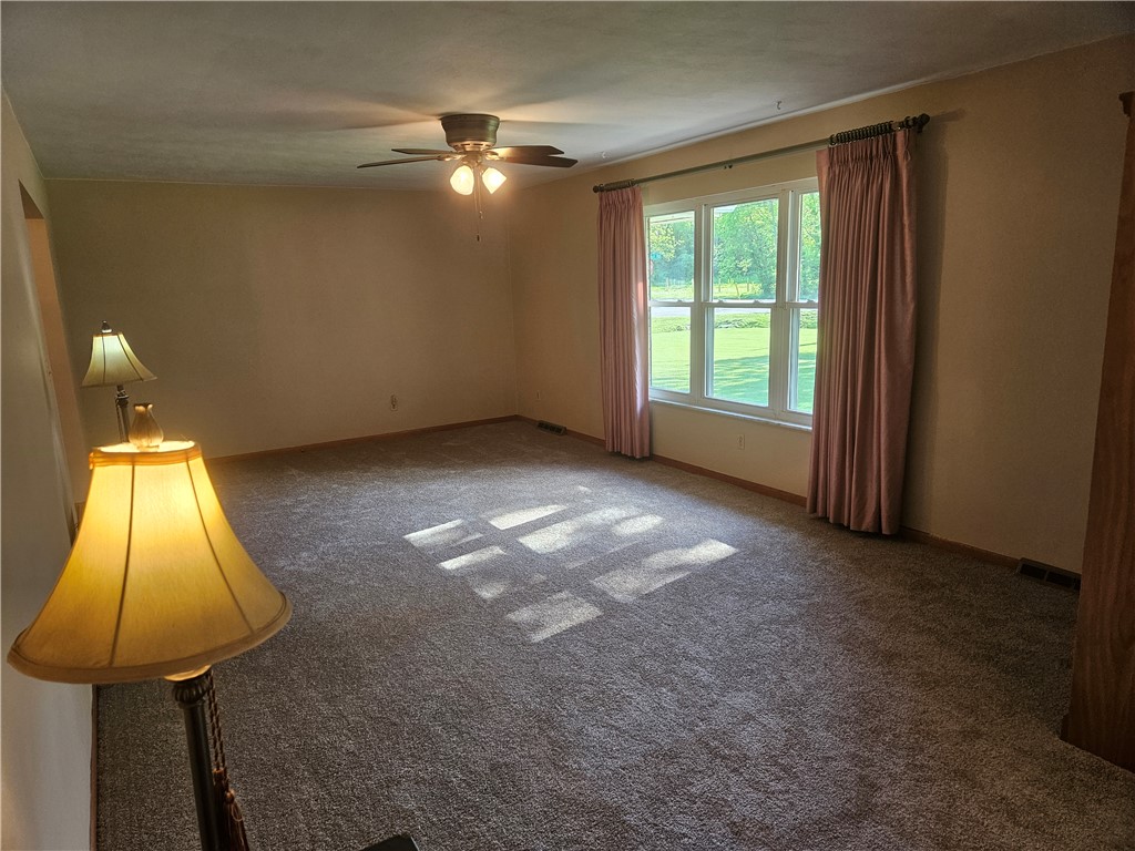 3998 Willowcrest Road Beavercreek, OH 45430 - Photo 16 of 41 This bright living space features soft carpeting and a window overlooking lush greenery.