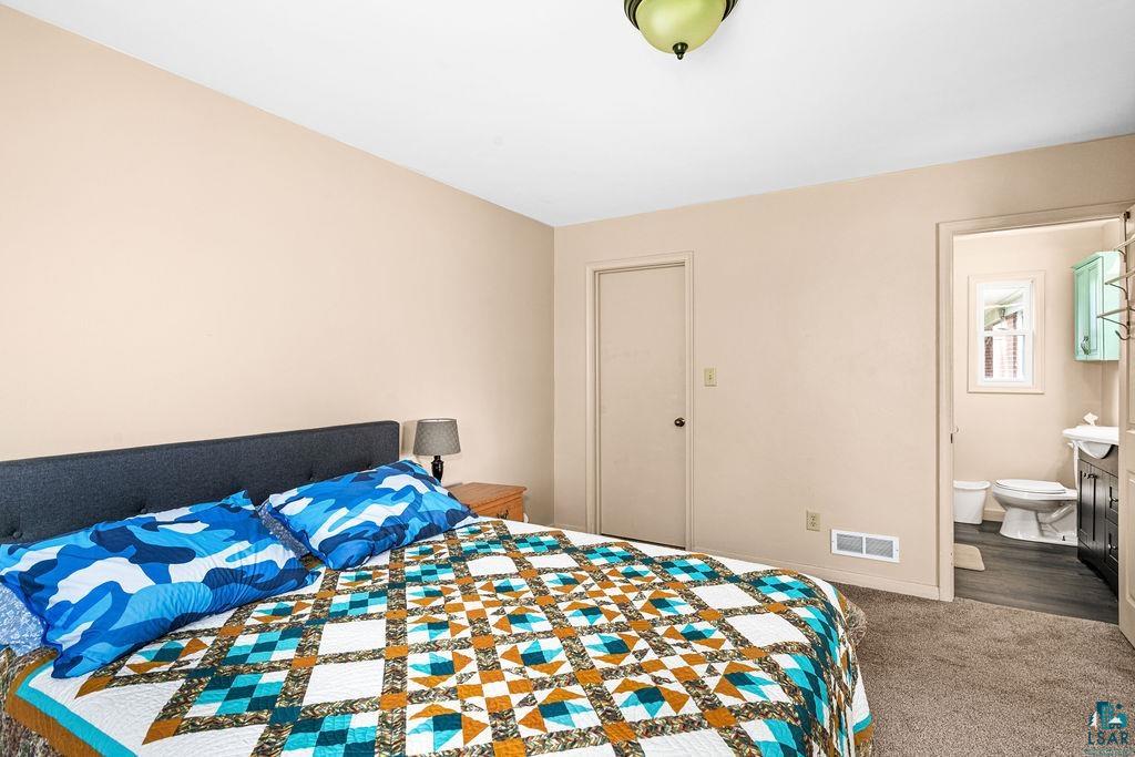 4543 County Road East South Range, WI 54874 - Photo 15 of 43 Carpeted room with neutral-toned walls, featuring an overhead light fixture
