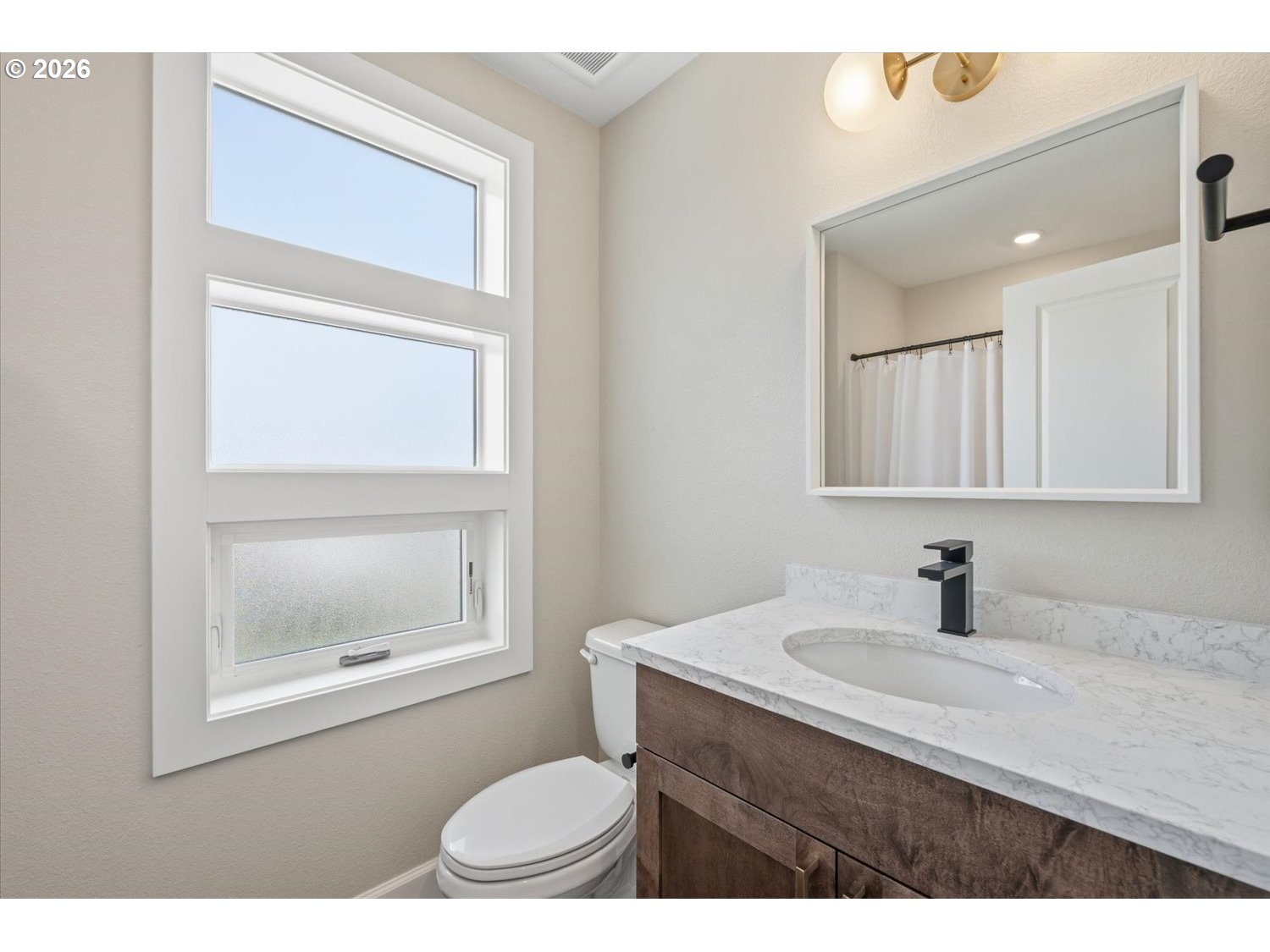 2059 Southeast 176th Avenue Portland, OR 97233 - Photo 25 of 31 a bathroom with a sink a toilet and a mirror