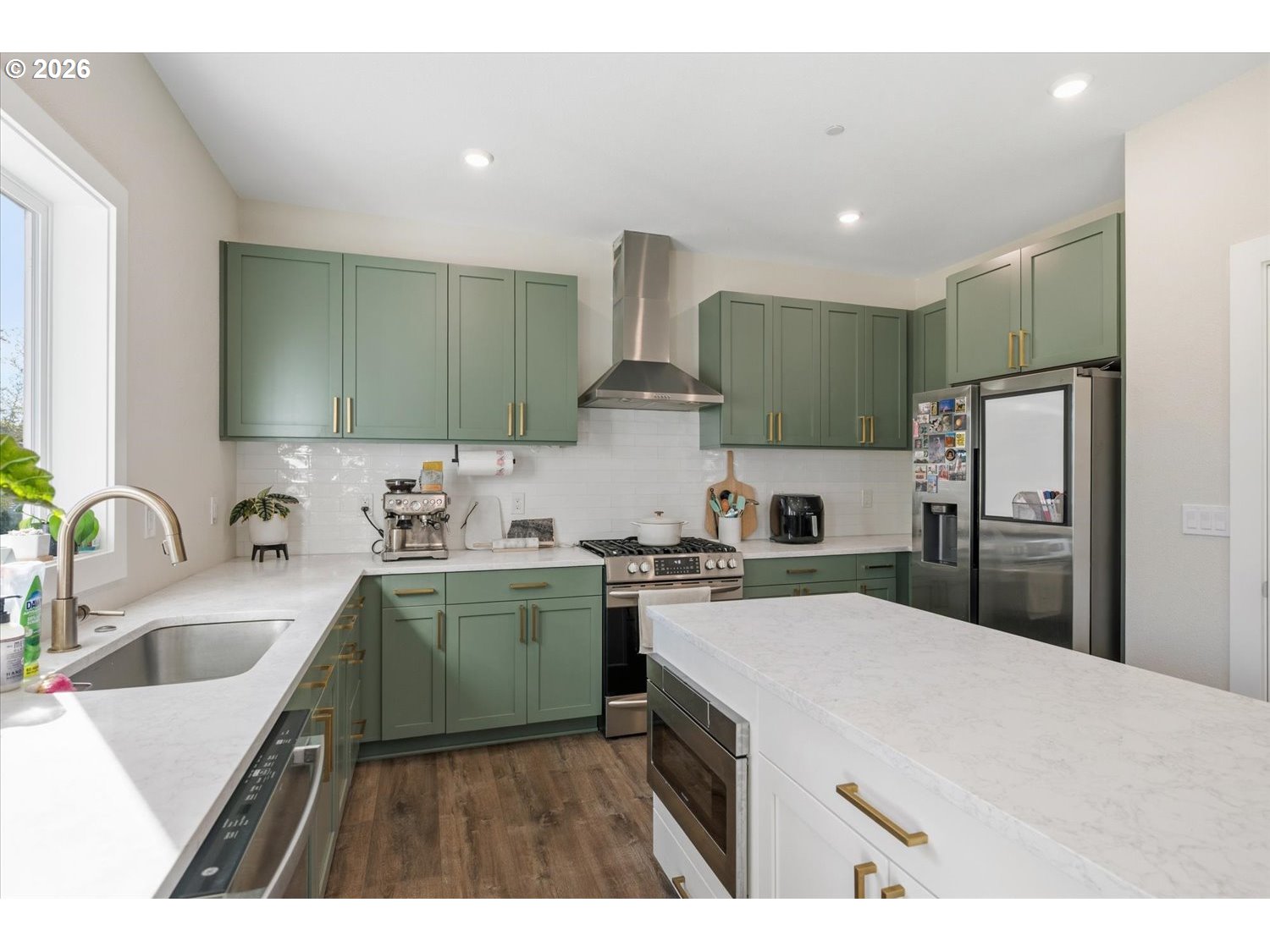 2059 Southeast 176th Avenue Portland, OR 97233 - Photo 6 of 31 a kitchen with kitchen island a sink stainless steel appliances and refrigerator