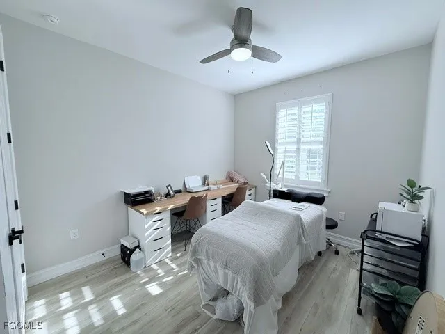 a bedroom with two beds and a chandelier