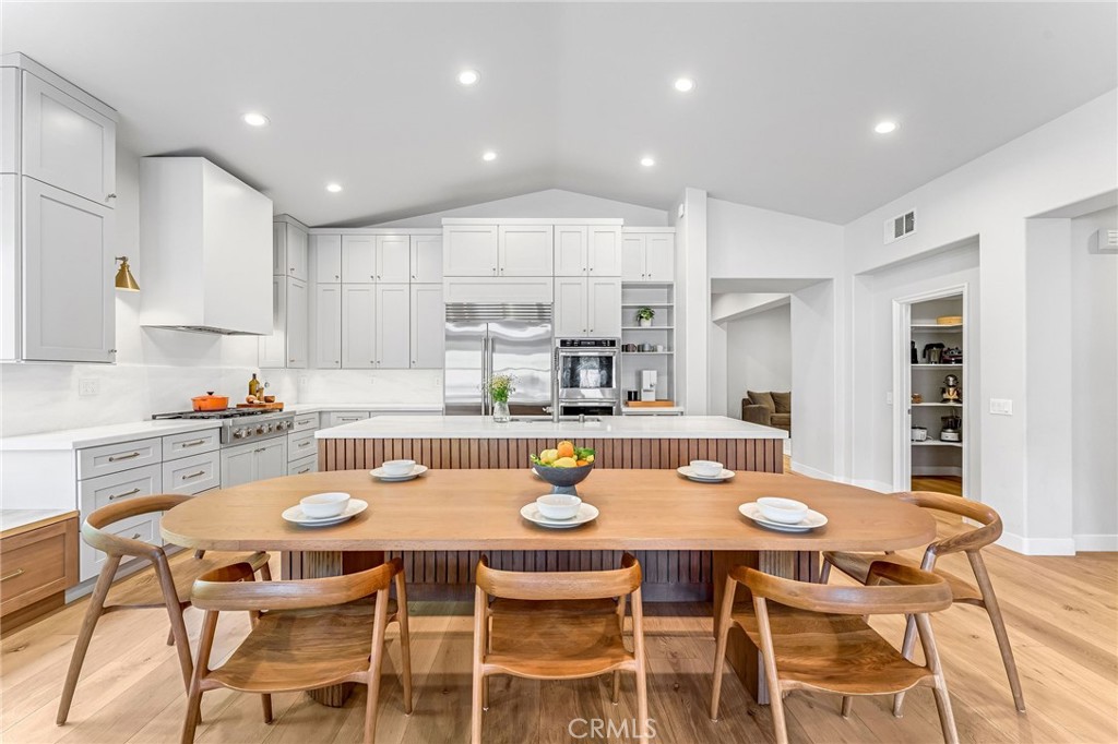 2269 Shady Oaks Road Glendora, CA 91741 - Photo 18 of 62 a kitchen with a dining table chairs and white cabinets